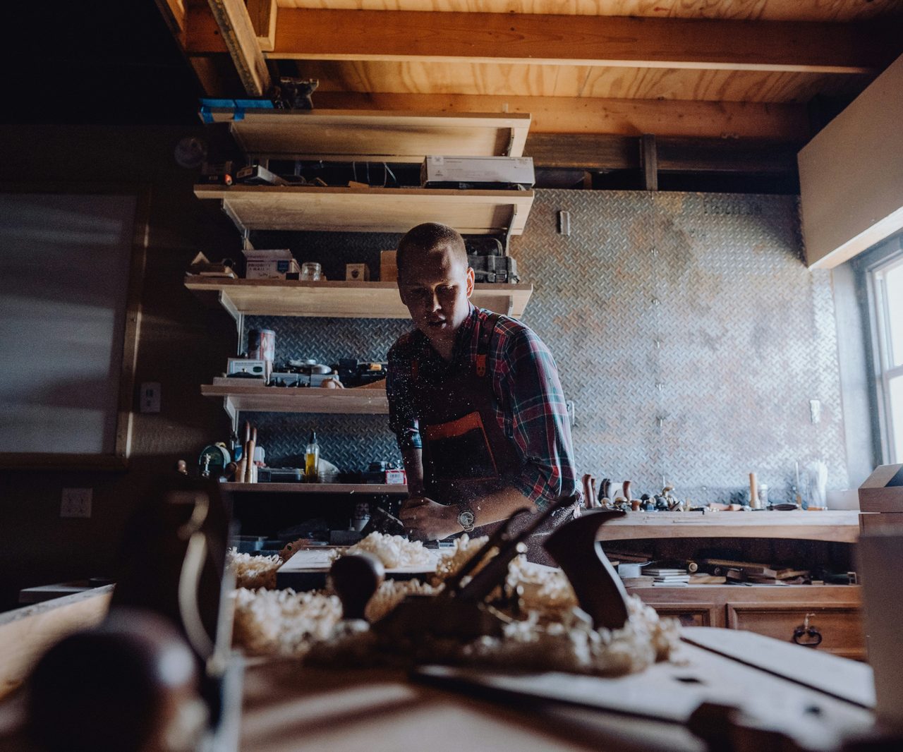 A craftsman working at his bench in his workshop