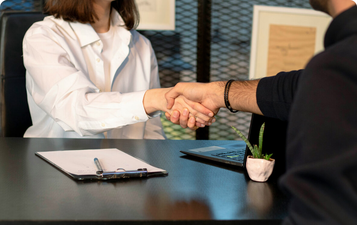 Two partners shaking hands in an office